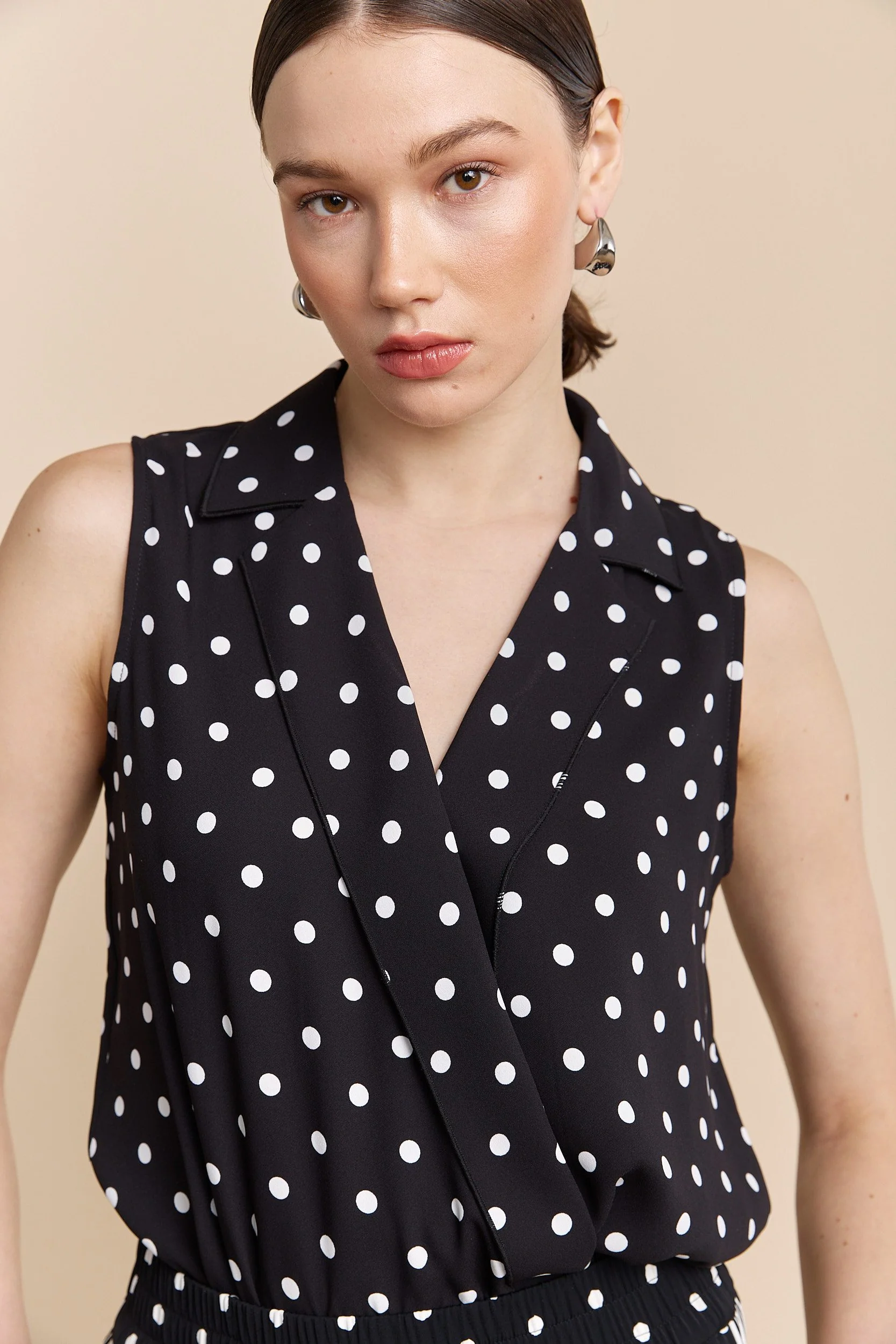 Polka dots sleeveless top with draped front